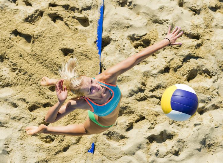 female volleyball player about to hit ball